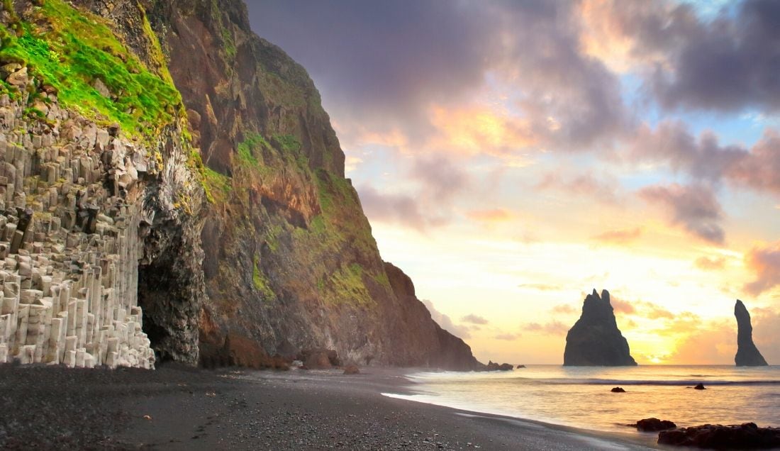 Visit the volcanic black sandy beaches