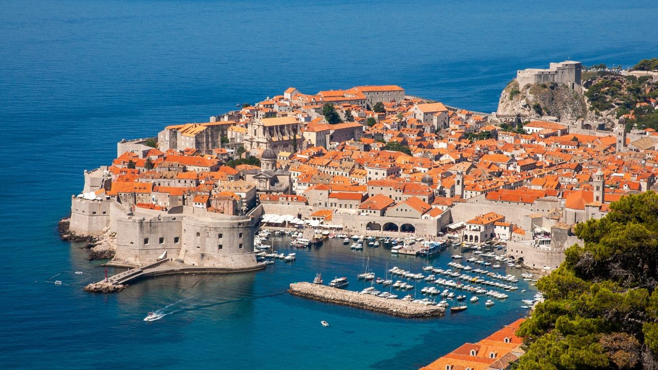 The image shows the city of Dubrovnik, a historic city in Croatia located on the Adriatic Sea. Often referred to as the "Pearl of the Adriatic," the city is known for its distinctive Old Town, which is a UNESCO World Heritage Site. 