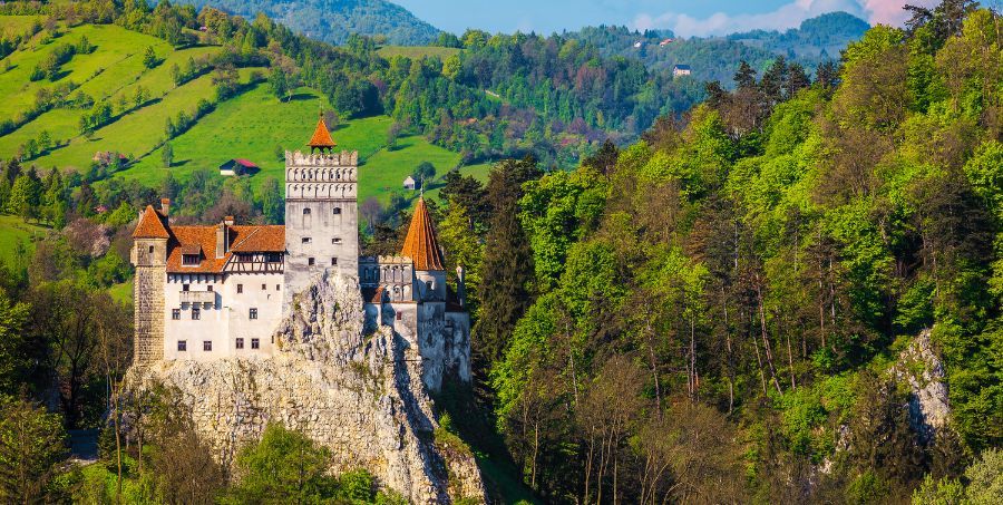 Bran-castle-green-forrest-Romania.jpg