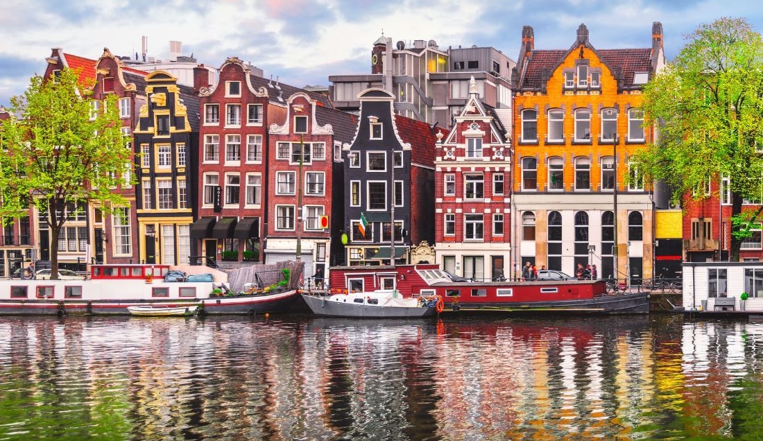 Visit the colourful canal houses in Amsterdam.